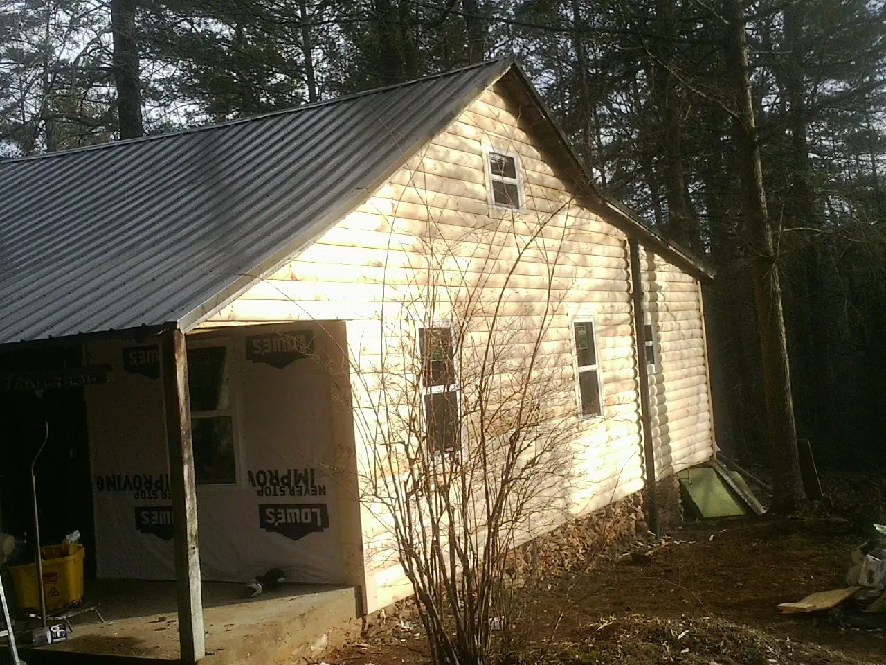 Log siding gable end under a dark metal roof edge in Nevada
