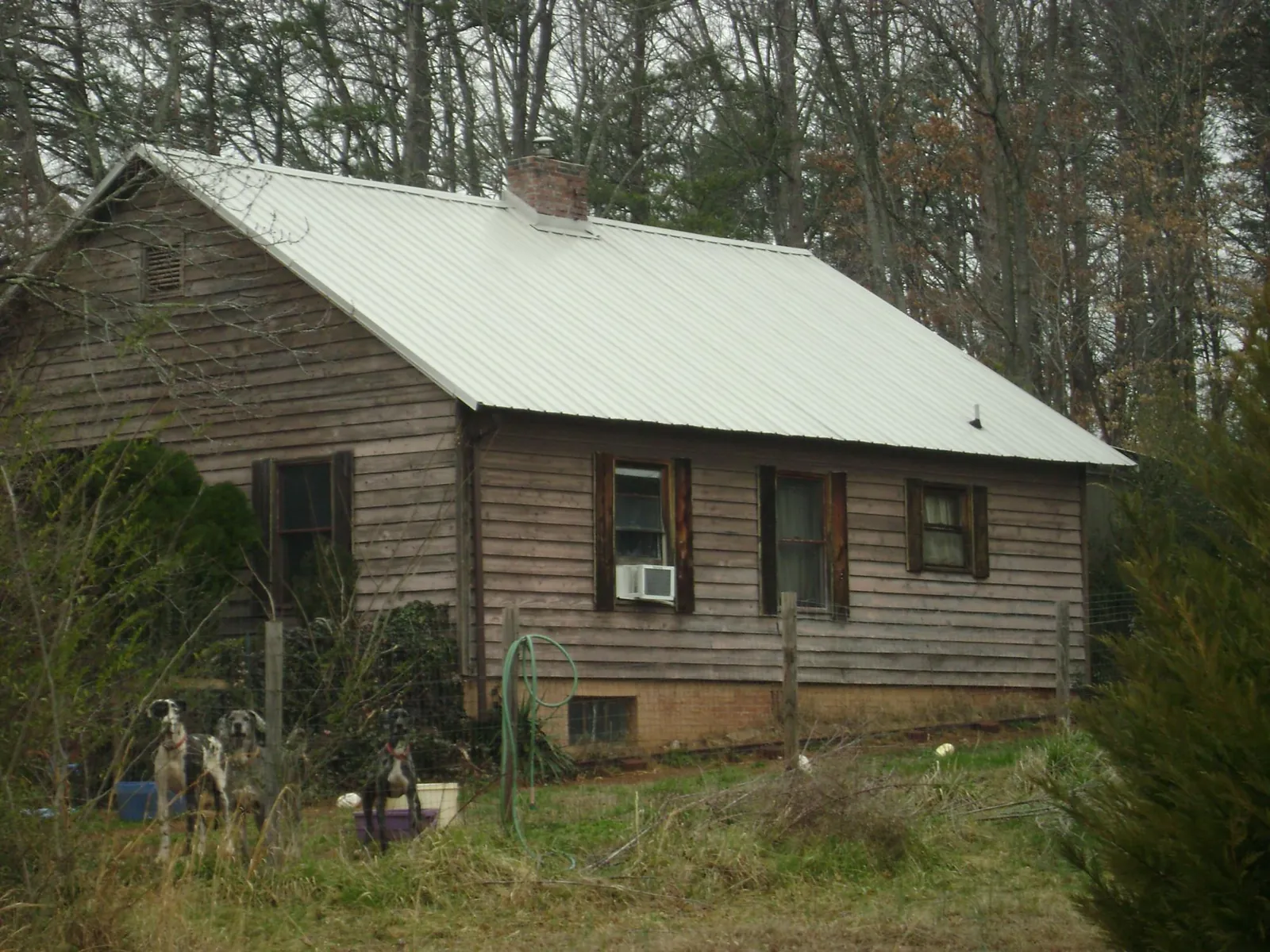White metal roof on an old wood sided farmhouse, from a Metal Roof Installation job in Nevada